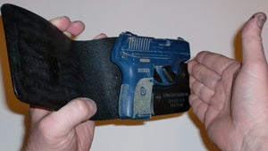 Wallet style top covered back pocket holster for licensed concealed weapon carry of Ruger LC9