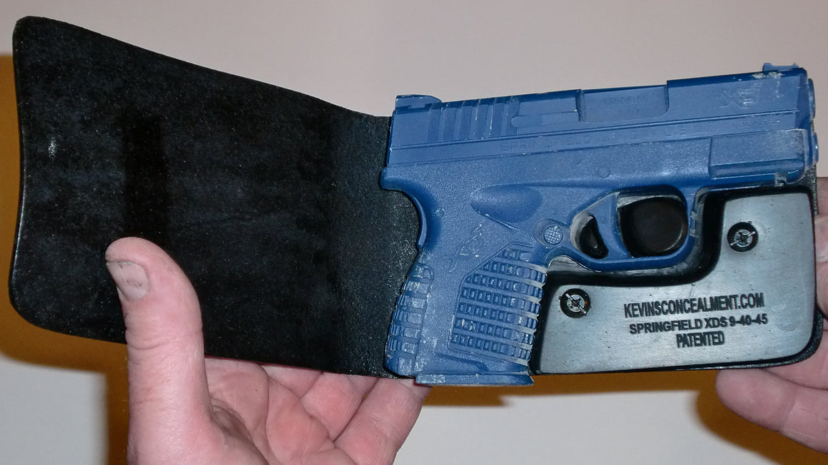 Wallet style top covered back pocket holster for licensed concealed weapon carry of Springfield XDS